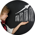 child in front of chalkboard with upward chart drawn